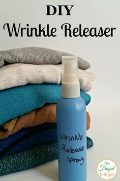 a bottle of wrinkle release spray sitting on top of some folded clothes with the words diy wrinkle release written on it