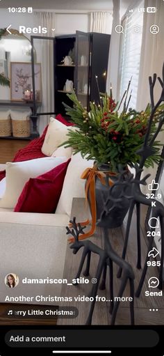 the living room is decorated for christmas with red and white decorations on the couches