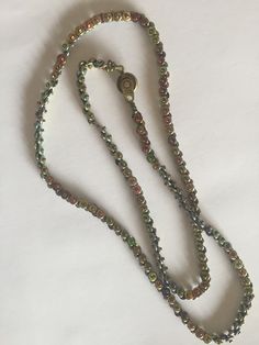 "This pattern is a simple chain but a great way to display a pendant. It uses either an \"O\" bead or Demi Round size 8 with either an 11 or 15 seed bead. It is a good basic pattern for a nice neck chain with beads. Light and easy. The pattern is 1 page in color and illustrated with diagrams. You will need a #10 or 11 needle to complete this piece and thread of choice. Often called bicycle chain due to the resemblance to that item. I prefer the Demi Round size 8 bead with 15's it is so delicate Metal Beaded Necklaces, Czech Glass Beaded Chain For Jewelry Making, Handmade Iridescent Round Bead Jewelry, Handmade Iridescent Jewelry With Round Beads, Metal Faceted Beads For Jewelry Making, Green Round Jewelry With Tiny Beads, Green Jewelry With Tiny Beads, Single Strand Czech Glass Beads For Jewelry Making, Adjustable Round Beaded Chain