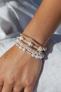 "Beautified with an assemblage of lustrous white freshwater pearl beads, this 18k gold filled pearl bracelet alludes to the soothing sands of Hawaii's shores. Wear this gold pearl bracelet alone or stacked for a classically elegant look. ✦ DETAILS ✦ ✧ Name: Hiwahiwa (HEEvah HEEvah) - precious, beloved, indulged. ✧ Adjustable Length from: 7\"-8.5\". ✧ White Freshwater Pearls. ✧ 14kt Gold Filled Components, Extender, and Clasp. ✧ All Ke Aloha Jewelry pieces come packaged thoughtfully, beautifully, Elegant Stackable Beaded Bracelets For Beach, Pearl Beaded Bracelets With Pearl Charm For Beach, Pearl Beaded Bracelets For Beach, White Pearl Bohemian Beaded Bracelets, Beach Beaded Bracelets With Pearl Charm, Bohemian White Pearl Beaded Bracelets, White Pearl Beaded Bracelets For Beach, Bohemian Pearl Bracelets With Pearl Charm, Bohemian Pearl Bracelets For The Beach