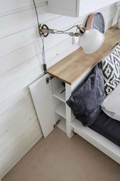 a bed with a wooden headboard and white walls