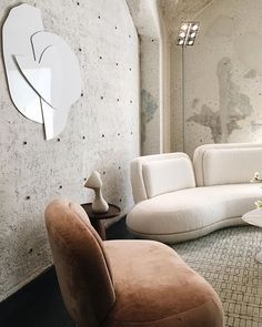 a living room filled with lots of furniture and walls covered in white speckles