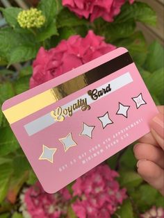 a person holding up a pink card with stars on it and the words enjoy band