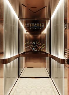 the elevator is very narrow and has glass doors on both sides that lead to other rooms