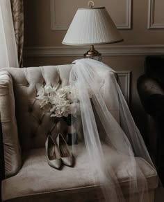 the bride's bouquet and shoes are on the couch