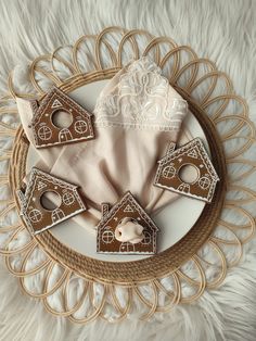 some cookies are sitting on top of a white plate with brown icing and decorations