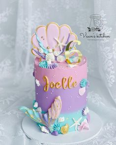 there is a colorful cake with shells on it