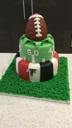 a football themed cake on top of green grass