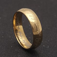 a gold wedding ring with the words lord and lady engraved on it's side