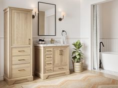 a bathroom with a sink, mirror and bathtub next to a rug on the floor