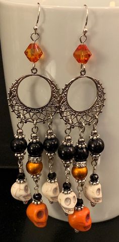 the earrings are decorated with skulls and beads