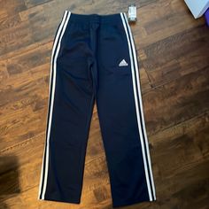 New With Tags Adidas Navy Blue Tricot Track Pants. Adidas Blue Sweatpants For Sports, Adidas Blue Sporty Sweatpants, Adidas Sporty Blue Sweatpants, Blue Cotton Pants With Three Stripes, Blue Adidas Cotton Sweatpants, Adidas Blue Cotton Pants, Adidas Blue Cotton Sweatpants, Navy Adidas Sporty Pants, Adidas Navy Sporty Pants