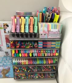 there are many pens and pencils on the shelf