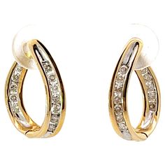 Earrings Specifications: Metal: 14k Yellow Gold Earring Length: 17.4 mm Total Weight: 3.4 Grams Diamonds: 24 Diamond Color: G-H Diamond Clarity: SI Diamond Carat Weight: 0.20 carats Condition: Preowned Stamped: "14k" Formal 14k Stamped Huggie Earrings, Formal Diamond Cut Hoop Earrings, Gold Diamond Earrings Channel Set For Anniversary, Gold Channel Set Diamond Earrings For Anniversary, Diamond Huggie Earrings With Polished Finish For Formal Occasions, Formal Diamond Huggie Earrings With Polished Finish, Yellow Gold Diamond Earrings With Channel Set, 14k Yellow Gold Channel Set Diamond Earrings, Classic Yellow Gold Earrings With Channel Set