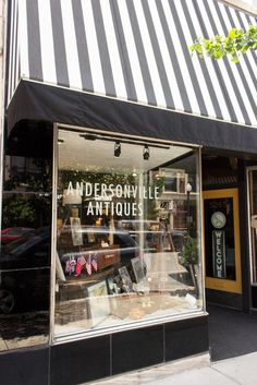 a store front with an awning on the side of it that says andersonsville antiques