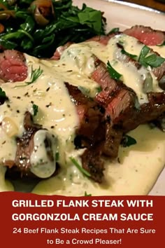 grilled flank steak with gorgonzoloa cream sauce on a white plate