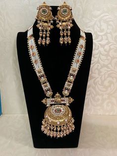 Traditional Polki pendant Long Pearl Necklace with Earring Polki refers to uncut diamonds that are set in traditional, often intricate, designs. These diamonds retain their raw form, giving the jewelry a vintage and royal look. Luxury Kundan Necklace For Rituals With Intricate Design, Luxury Long Temple Necklace For Gift, Luxury White Temple Necklace For Reception, Luxury Jeweled Elegant Temple Necklace, Luxury Formal Temple Necklace With Pendant, Traditional Luxury Long Necklace As A Gift, Luxury Temple Style Statement Necklaces, Long Necklaces Gold Indian, Luxury Traditional Beaded Temple Necklace