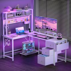 a computer desk with purple lighting in a room