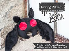 a stuffed animal laying on the ground next to a sign that says sewing pattern by belife cost