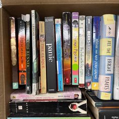 a box filled with lots of books sitting on top of a table