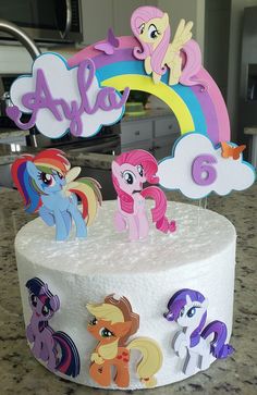 there is a cake that has many little ponys on it