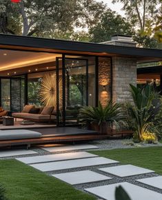 a modern house with an outdoor patio and seating area