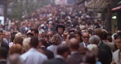 a crowd of people walking down a street