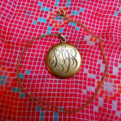 "Beautiful example of a classical monogrammed locket from the Edwardian era. Three letters are hand-engraved at the front of the locket, the back is plain. I read \"TOS\" but the first letter is ambiguous. Details: The locket is from the 1910s. I believe it is made of gold filled. It is in excellent condition, very little surface wear and no dent. Inside there is a symbol, probably the maker mark, which represents a flower with two leaves. It opens from the top, and shuts tightly with a snap. In Vintage Jewelry Initial Pendant For Personalized Gift, Vintage Locket Necklace For Personalized Gift, Gold Etched Locket Necklace, Monogram Medallion Jewelry For Gift, Vintage Personalized Pendant Jewelry Gift, Monogrammed Medallion Jewelry For Gift, Vintage Medallion Jewelry For Personalized Gift, Vintage Pendant Jewelry For Personalized Gift, Vintage Engraved Oval Pendant Locket Necklace