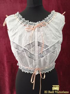 This Edwardian-style corset cover is made in 100% cotton voile. It is trimmed with lace insertion, creating a diamond pattern across the chest. The fronts are gathered at the waist, to create that pigeon bust effect so prevalent of the period. At the back, it has eight small darts to give some shape. At the neckline in front and the armsyce on the back it is trimmed with very fine pintucks. The neckline, waistline and armholes are trimmed with beading lace, so they can be drawn and adjusted. It Thrift Inspiration, Lace Insertion, Edwardian Corsets, Corset Cover, Uni Fits, Find Style, Vintage Cowgirl, Fits Inspo, Edwardian Fashion