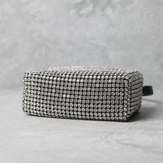 The Maison's dark elegance is the key feature of this genuine calfskin small clutch with rotating metal closure on the top. It has a detachable leather shoulder strap. The inside is fully lined and features a mirror and a ""You look great today"" embroidery. Fully emcrusted with swarovski stones. Measures: h cm 17, w cm 10, d cm 7. [custom tab]SHELL #1: 100% CALF LEATHER | INTERNAL INSERT 1#: 100% CALF LEATHER | LINING #1: 100% POLYESTER | FILLING #1: 50% POLYAMIDE 50% POLYURETHANE [/custom tab] Clear Clutch, Faux Fur Purse, Clutch Purse Black, Fur Purse, Dark Elegance, Swarovski Stones, Small Clutch, Rhinestone Designs, Leather Bag Women