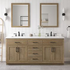 a bathroom with two sinks and mirrors on the wall