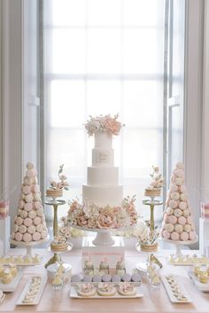 a table topped with lots of cakes and desserts