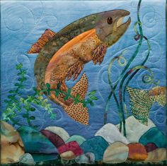 a quilted wall hanging with fish and seaweed