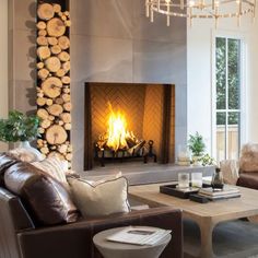 a living room filled with furniture and a fire place in the middle of a fireplace