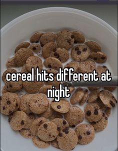 the words cereal hits different at night in front of a bowl of chocolate chip cookies