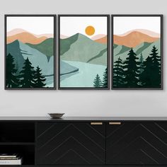 three paintings hanging on the wall above a dresser in a room with a black cabinet