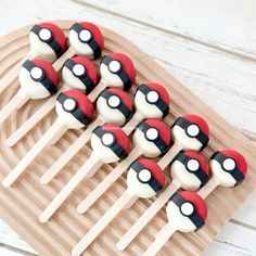 there are some cake pops decorated like pokemon pikachus on a wooden platter