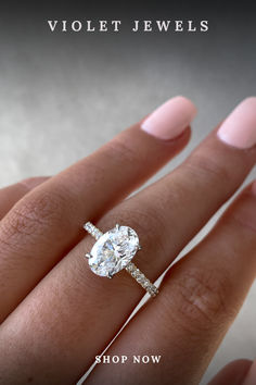 a woman's hand with a diamond ring on her finger and the words violet jewels