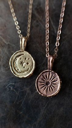 Lume - Unique Hand-Crafted Sun and Moon Necklaces in Recycled Solid Gold | Rhodes Wedding Co. Sun And Moon Necklace Couples, Sun And Moon Matching Necklaces, Brass Amulet Necklace With Moon Charm, Handmade Brass Celestial Necklace, Amulet Style Necklace With Moon Charm In Brass, Artisan Moon Charm Necklaces, Artisan Moon Phase Jewelry Gift, Celestial Hand Forged Necklace Gift, Celestial Jewelry With Sun And Moon Designs