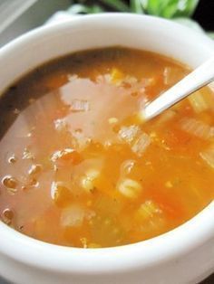 a white bowl filled with soup on top of a table