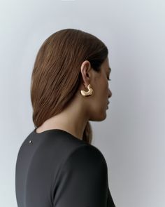 A pair of sleek, sculptural mini hoops, handmade by artisans in New York City from a 14-karat gold-plated recycled brass with a scooped-out interior for lightness. Chic Gold Hammered Hoop Earrings, Gold-tone Hoop Earrings For Evening, Chic Brass Hoop Earrings For Formal Occasions, Modern Gold Plated Hoop Earrings For Evening, Minimalist Gold-tone Hoop Earrings For Formal Occasions, Modern Gold-plated Hoop Earrings For Evening, Modern Hammered Hoop Earrings For Formal Events, Modern Hammered Hoop Earrings For Formal Occasions, Modern Gold Sculptural Jewelry