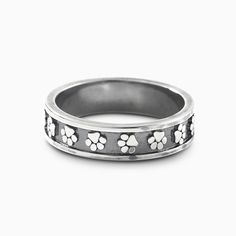 a wedding ring with paw prints on the side and hearts in the middle, set against a white background