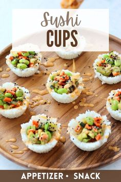 sushi cups on a wooden platter with cashews and peanuts in the background