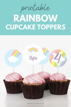 three cupcakes with pink frosting and rainbow toppers