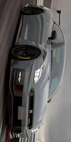 a car with speakers attached to it's side hanging from the wall in front of a window