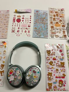 various stickers and headphones on a table