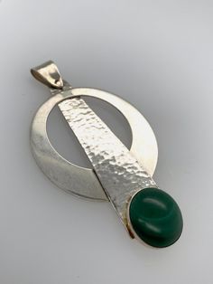 Modern Green Pendant Jewelry, Modern Polished Emerald Jewelry, Modern Green Cabochon Jewelry, Modernist Round Cabochon Jewelry, Green Sterling Silver Hammered Jewelry, Green Hammered Sterling Silver Jewelry, Modern Green Round Pendant Jewelry, Elegant Silver Malachite Jewelry, Modern Green Circular Jewelry