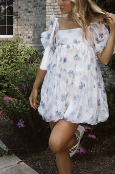 Sweeten up your wardrobe with our Girlhood Floral Dress! This dress features a playful bubble hem and a cute floral print, perfect for any fun occasion. Add a touch of sweetness to your style with this must-have dress! 100% Polyester, Lining 100% Cotton Hand wash cold! Summer Floral Print Mini Dress With Puff Sleeves, Summer Floral Print Dress With Puff Sleeves, Summer Dresses With Floral Print And Puff Sleeves, Floral Print Puff Sleeve Mini Dress, Cute Blue Floral Dress For Spring, Chic Bubble Hem Mini Dress For Spring, Summer Floral Print Puff Sleeve Dress, Summer Floral Dress With Puff Sleeves, Flowy Floral Print Puff Sleeve Dress For Garden Party