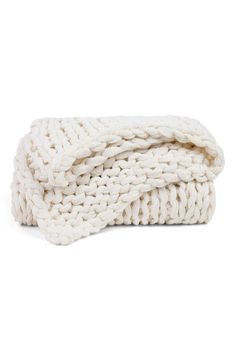 a white knitted blanket folded on top of each other