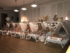 a group of women sitting on top of white couches